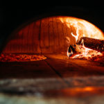 Traditional way baked pizza in a wood fired oven.